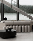 A quirky modern living room with stairs leading to a lake, adorned with 101Cph Guggenheim Petit Black 213042 artwork and unique vases by 101 Copenhagen.