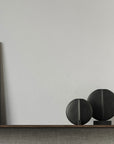 A wooden shelf with two 101Cph Guggenheim Petit Black 213042 vases from the brand 101 Copenhagen and a painting on it.
