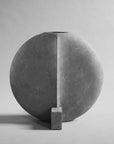 Gray sculptural vase with a geometric design on a gray background from 101 Copenhagen at Spacio retail stores in Mumbai & Kolkata.