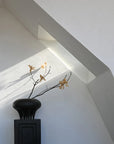 A 101Cph Medusa Vase Big Coffee 221061 from 101 Copenhagen sits on top of an attic window.