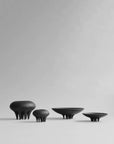 A group of 101Cph Medusa Vase Mini Coffee 221062 by 101 Copenhagen ceramic bowls in a room.