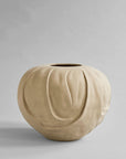 Beige ceramic vase on a gray background from 101 Copenhagen at Spacio retail stores in Mumbai & Kolkata.