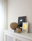 Decorative items on a white shelf against a light wall from 101 Copenhagen at Spacio retail stores in Mumbai & Kolkata.