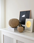 Decorative items on a white shelf against a light wall from 101 Copenhagen at Spacio retail stores in Mumbai & Kolkata.