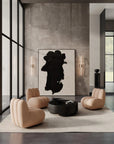 Modern living room with beige armchairs, a black coffee table, and abstract wall art from 101 Copenhagen