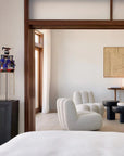 Modern bedroom with white furniture, decorative lamp, and wall art from 101 Copenhagen