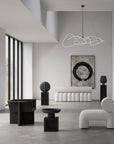 Modern interior with black and white furniture and abstract art.