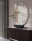 Decorative mirror with a plant in a 101 Copenhagen Shinju platter on a wooden console against a neutral wall.