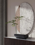 Decorative mirror with a plant in a 101 Copenhagen Shinju platter on a wooden console against a neutral wall.