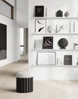 A white and black living room with shelves and a stool, featuring Scandinavian brand furniture and accents including the 101 Copenhagen Sphere Bubl Mini Dark Grey 111029.