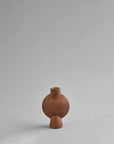A 101Cph Sphere Bubl Mini Terracotta 203010 vase on a grey background by 101 Copenhagen.