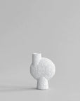 A white vase on a grey background, showcasing the Bone White finish from the Scandinavian brand 101 Copenhagen.