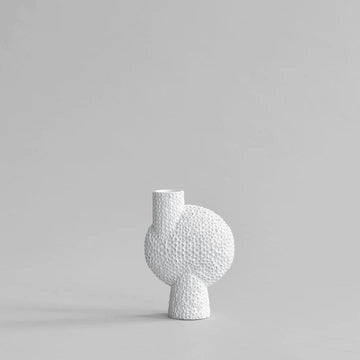 A white vase on a grey background, showcasing the Bone White finish from the Scandinavian brand 101 Copenhagen.