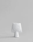 A 101Cph Sphere Square Shisen Mini Bone White 231012 table lamp on a grey background, showcasing a decorative and sculptural manner with its bone white finish.
