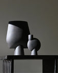 Two sculptural vase on the arc console table against a plain wall from 101 Copenhagen at Spacio retail stores in Mumbai & Kolkata.