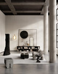 Modern living room with minimalistic decor and large columns.