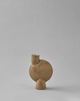 Brown ceramic vase with a unique design on a gray background from 101 Copenhagen at Spacio retail stores in Mumbai & Kolkata.