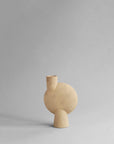 Beige ceramic vase on a gray background from 101 Copenhagen at Spacio retail stores in Mumbai & Kolkata.