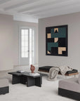 Modern living room with abstract art on the wall and minimal furniture.