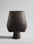 The 101Cph Sphere Vase Square Big Coffee 111183, from the 101 Copenhagen brand's Sphere collection, is a stunning dark brown vase that stands out against a clean white background.