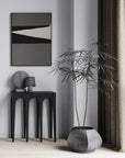 A 101 Copenhagen living room with a potted plant and the 101Cph Sphere Vase Square Mini Dark Grey 111020 from the Sphere collection.