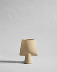 Beige ceramic sculptural vase with a plain background from 101 Copenhagen at Spacio retail stores in Mumbai & Kolkata.