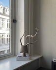 Decorative sculptural vase on a windowsill with a view of a building outside from 101 Copenhagen at Spacio retail stores in Mumbai & Kolkata.