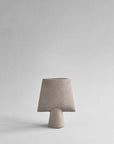 Beige ceramic vase on a light gray background from 101 Copenhagen at Spacio retail stores in Mumbai & Kolkata.