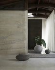 Minimalist interior with stone walls, a plant, and decorative vases from 101 Copenhagen at Spacio retail stores in Mumbai & Kolkata.
