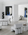 Modern living room with white furniture and abstract art