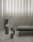 Modern interior with abstract sculptures and a bench against a textured wall from 101 Copenhagen at Spacio retail stores in Mumbai & Kolkata.