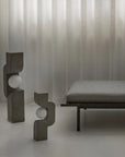 Modern interior with abstract sculptures and a bench against a textured wall from 101 Copenhagen at Spacio retail stores in Mumbai & Kolkata.