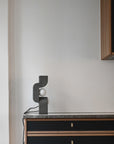 Modern lamp on a sideboard against a plain wall from 101 Copenhagen at Spacio retail stores in Mumbai & Kolkata.