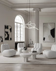 Modern living room with white furniture and abstract art