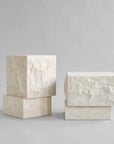 Pair of high and low rectangular limestone plinth on a gray background from 101 Copenhagen at Spacio retail stores in Mumbai & Kolkata.