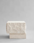 Side view of a rectangular limestone plinth on a gray background from 101 Copenhagen at Spacio retail stores in Mumbai & Kolkata.