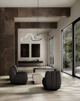 Modern living room with gray chairs, a coffee table, and a stylish chandelier.