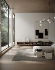 Modern living room with large windows, neutral decor, and a chandelier.