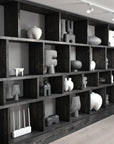 A room with shelves full of 101Cph Tribal Vase Big Dark Grey 214005 vases from the 101 Copenhagen Tribal Collection. Available at Spacio India