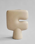 Beige sculptural vase in a light gray background from 101 Copenhagen at Spacio retail stores in Mumbai & Kolkata.