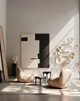 Modern interior with two beige chairs, a abstract painting, and decorative wall pieces.