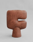 Brown sculptural vase on a gray background from 101 Copenhagen at Spacio retail stores in Mumbai & Kolkata.