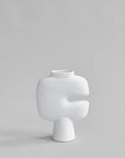 White sculptural vase on a light gray background from 101 Copenhagen at Spacio retail stores in Mumbai & Kolkata.