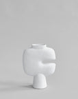 White sculptural vase on a light gray background from 101 Copenhagen at Spacio retail stores in Mumbai & Kolkata.