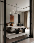 Modern bedroom with a bed, side tables, and abstract wall art.