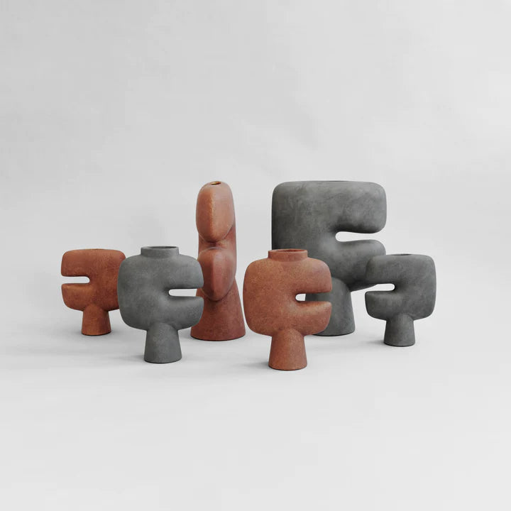 A collection of 101Cph Tribal Vase Medio Terracotta 214004 by 101 Copenhagen with different shapes and terracotta colors. Available at Spacio India