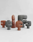 A collection of 101Cph Tribal Vase Medio Terracotta 214004 by 101 Copenhagen with different shapes and terracotta colors. Available at Spacio India