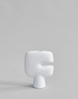 White ceramic vase on a gray background from 101 Copenhagen at Spacio retail stores in Mumbai & Kolkata.