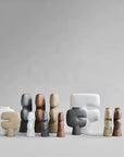 A collection of 101Cph Tribal Vase Minis in different shapes and sizes, placed on a mesmerizing grey background. Available at Spacio India