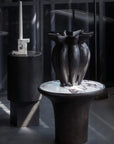 Dark vase on a calacatta marble top side table with a blurred background from 101 Copenhagen at Spacio retail stores in Mumbai & Kolkata.